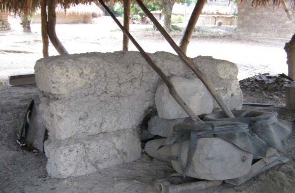 Source: Field trip observation-11/03/2012 Plate II: Pieces of Iron/metal scraps at an ate iwa (smithy). The iron scraps form the major raw material for the black smith. These are heat in the coals and shaped in different sizes of implements Plate IV: The clay nozzle for the fire. Note the coals in which pieces of iron scraps are buried for heating and formed into different farm implements Source: Field trip observation-11/03/2012 Plate V: A Blacksmith Mr. Iornenge Hom stands beside his ate iwa (smithy) during the oral interview at Betse-Mbaduku, Vandeikya LGA of Benue state Source: Field trip observation-11/03/2012 Volume XVI Issue VII Version I VI: A Blacksmith Mr. Iornenge Hom sits in his ate iwa (smithy) demonstrating the usage of the bellowing poles at Betse-Mbaduku, Vandeikya LGA of Benue state.